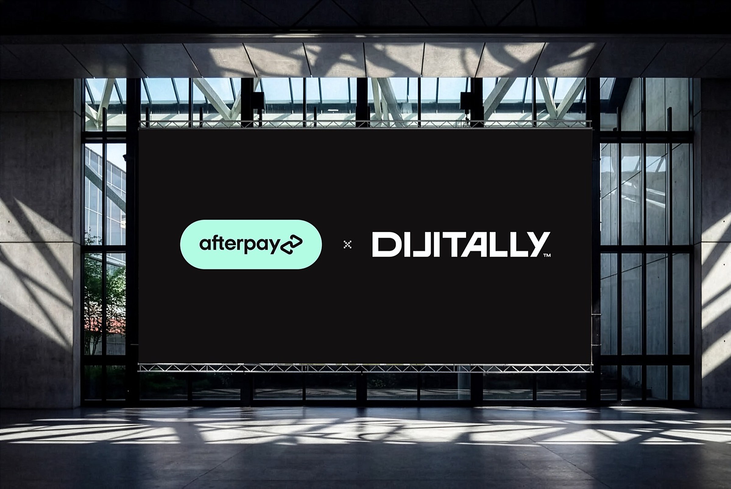 Afterpay and Dijitally logos locked up on a large digital billboard in a glass atrium