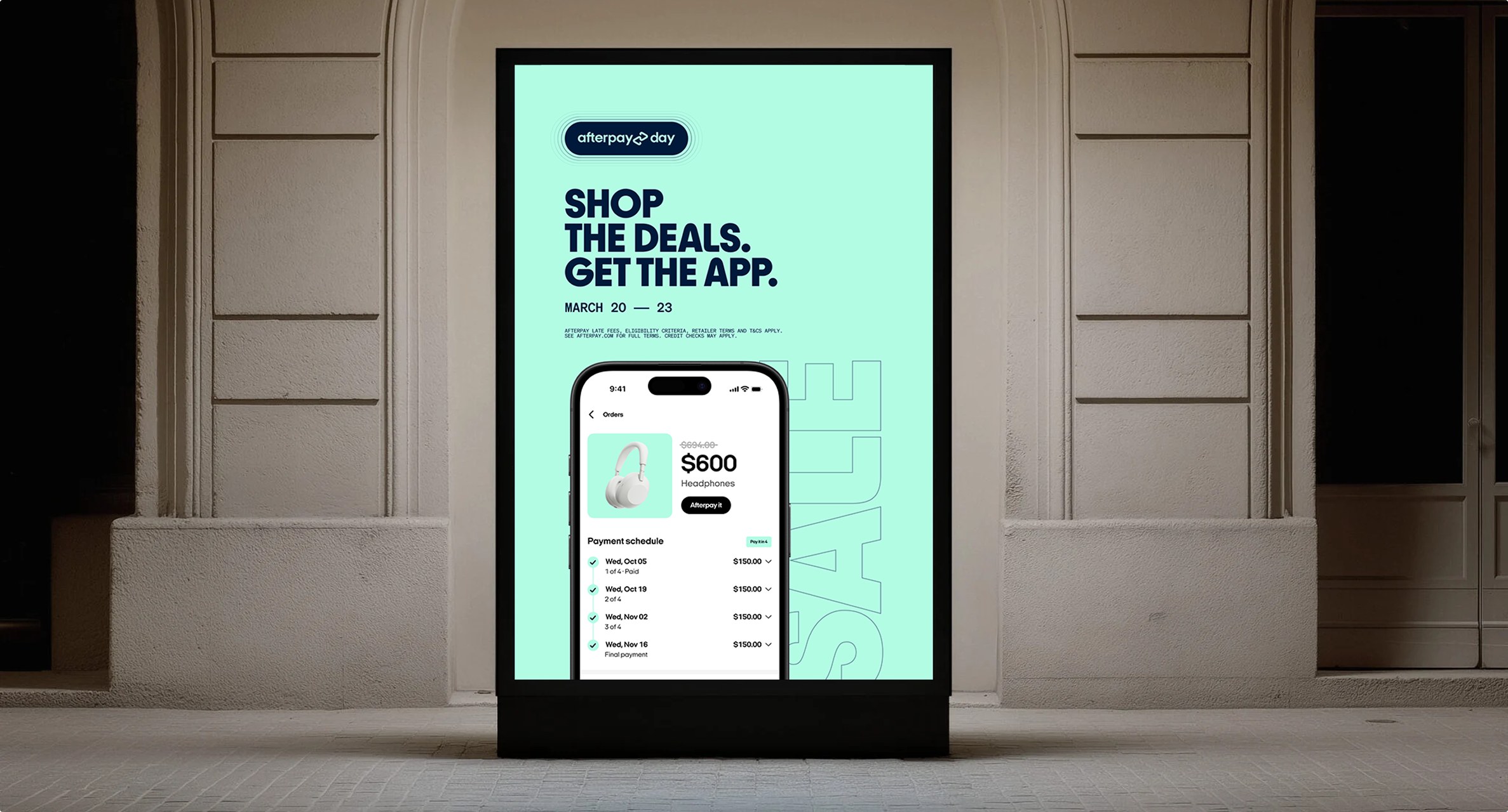 Mint green street poster reading Shop the deals, get the app, with the Afterpay app on a phone